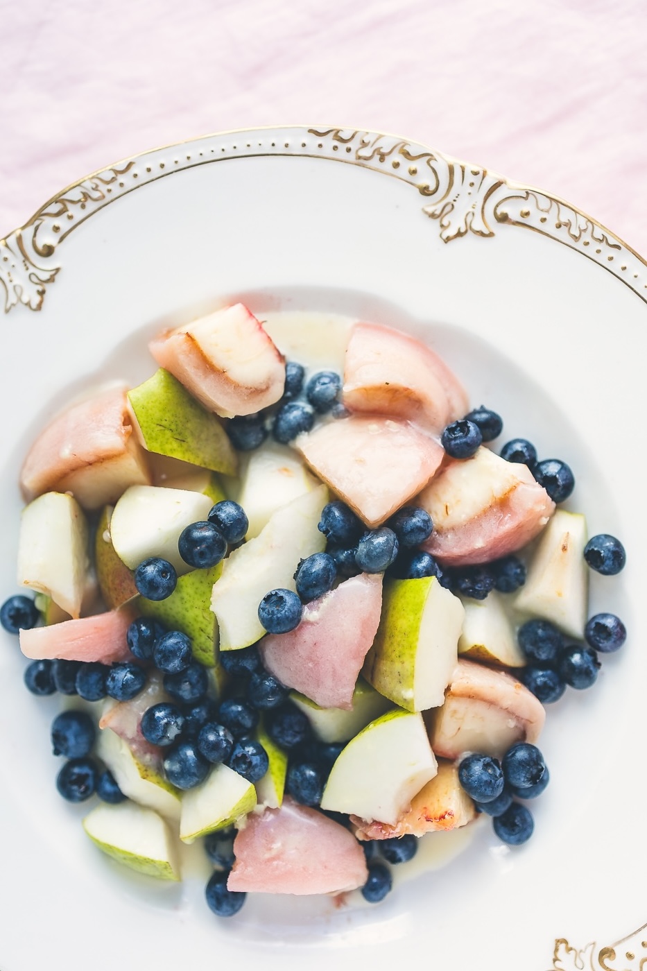 Summer fruit salad with peaches, pears and blueberries in a ginger coconut dressing — an easy no-bake dessert for brunch, potlucks and Labor Day weekend. Peeled white peaches, green pear with the skin on, cold raw blueberries, and a four-ingredient dressing you whisk in a bowl. Vegan, dairy free, gluten free, no refined sugar. Twenty minutes, seven ingredients, serves four. One of three late summer salad recipes on the blog.