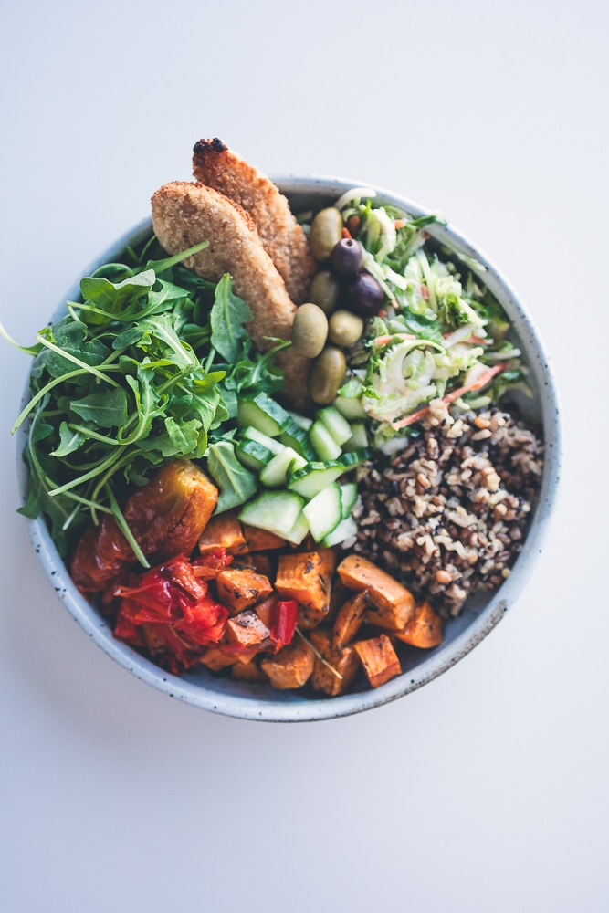 Plant-based grain bowl with roasted vegetables and crunchy Brussels sprout slaw