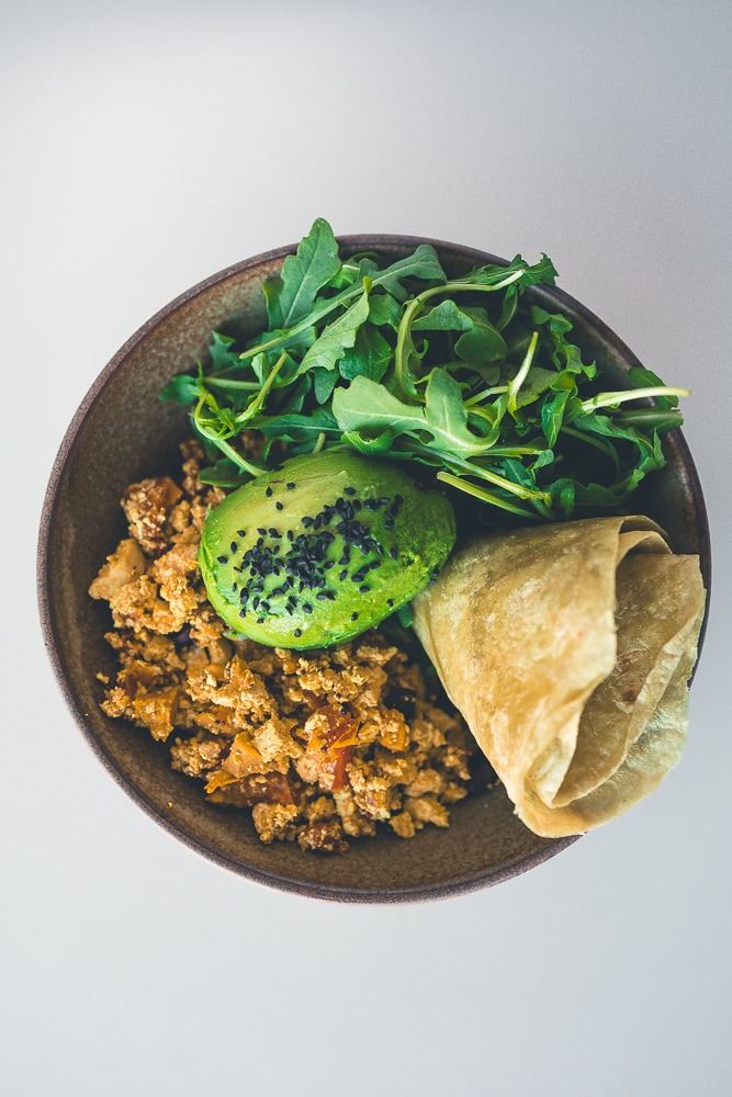 Tofu scramble with avocado, black sesame and a warm tortilla